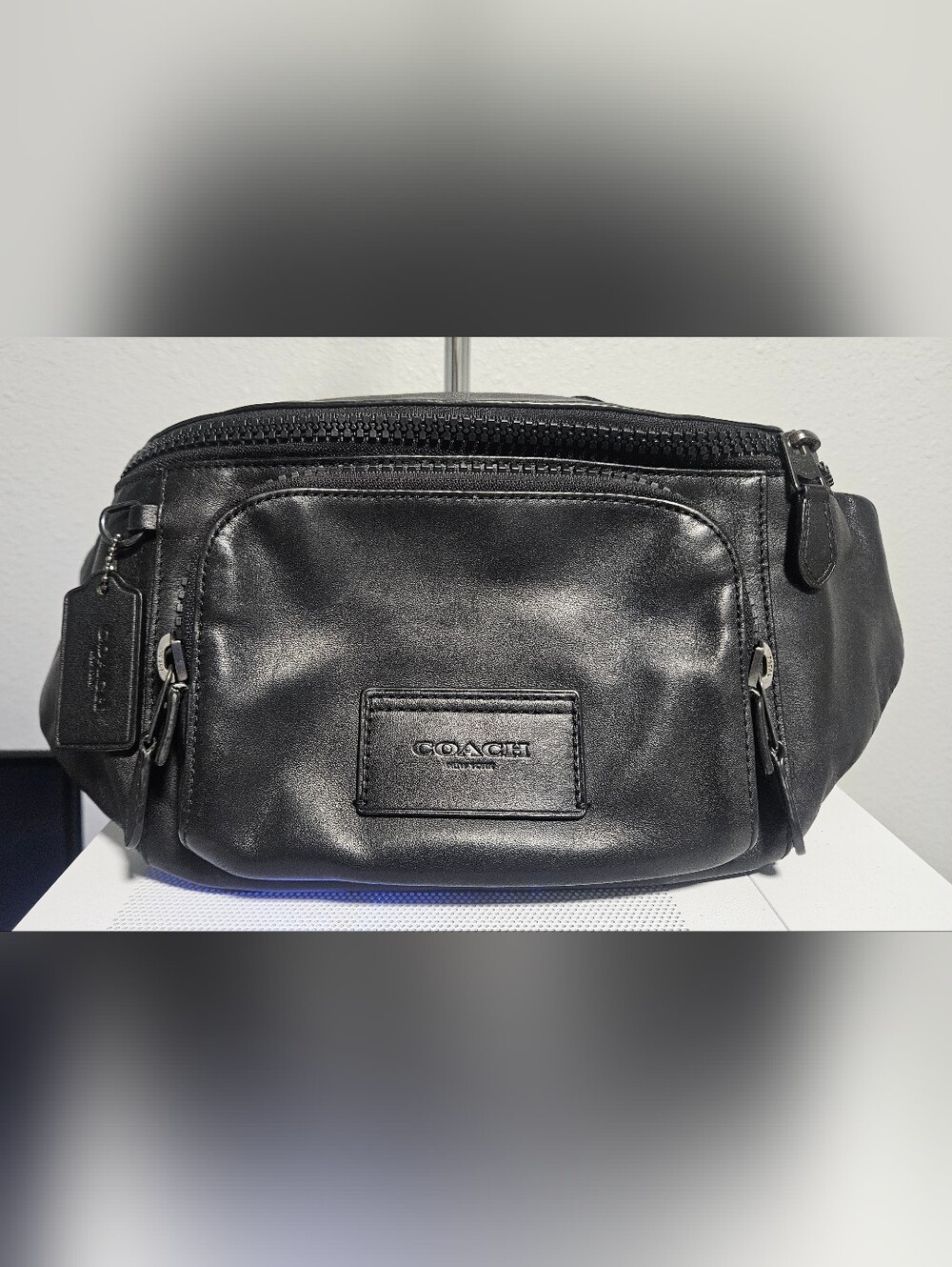 Coach Track Belt Bag in smooth black leather with gunmetal hardware.